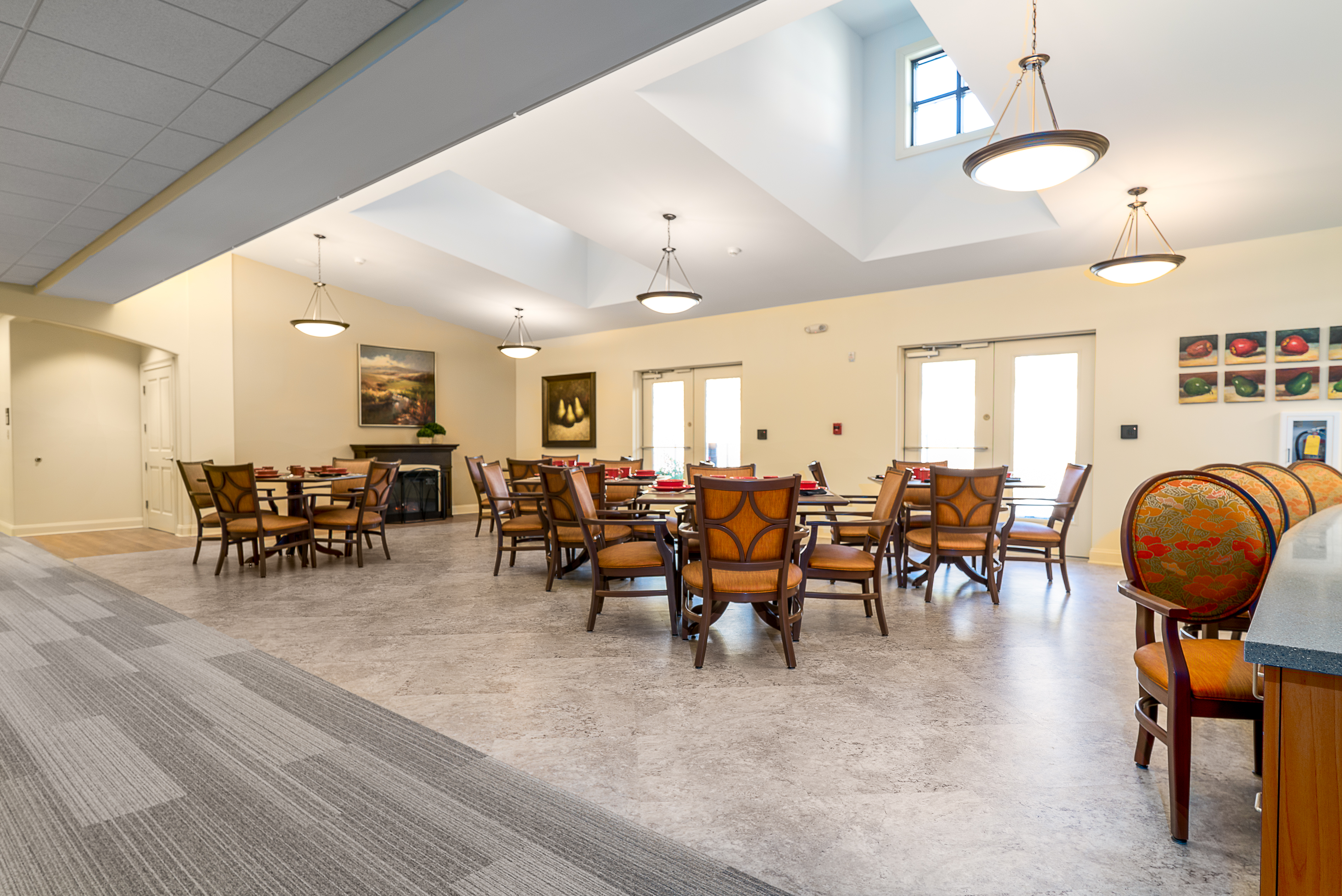 Interface Shiver Me Timbers plank carpet tile with Natural Stones square LVT in senior housing dining area