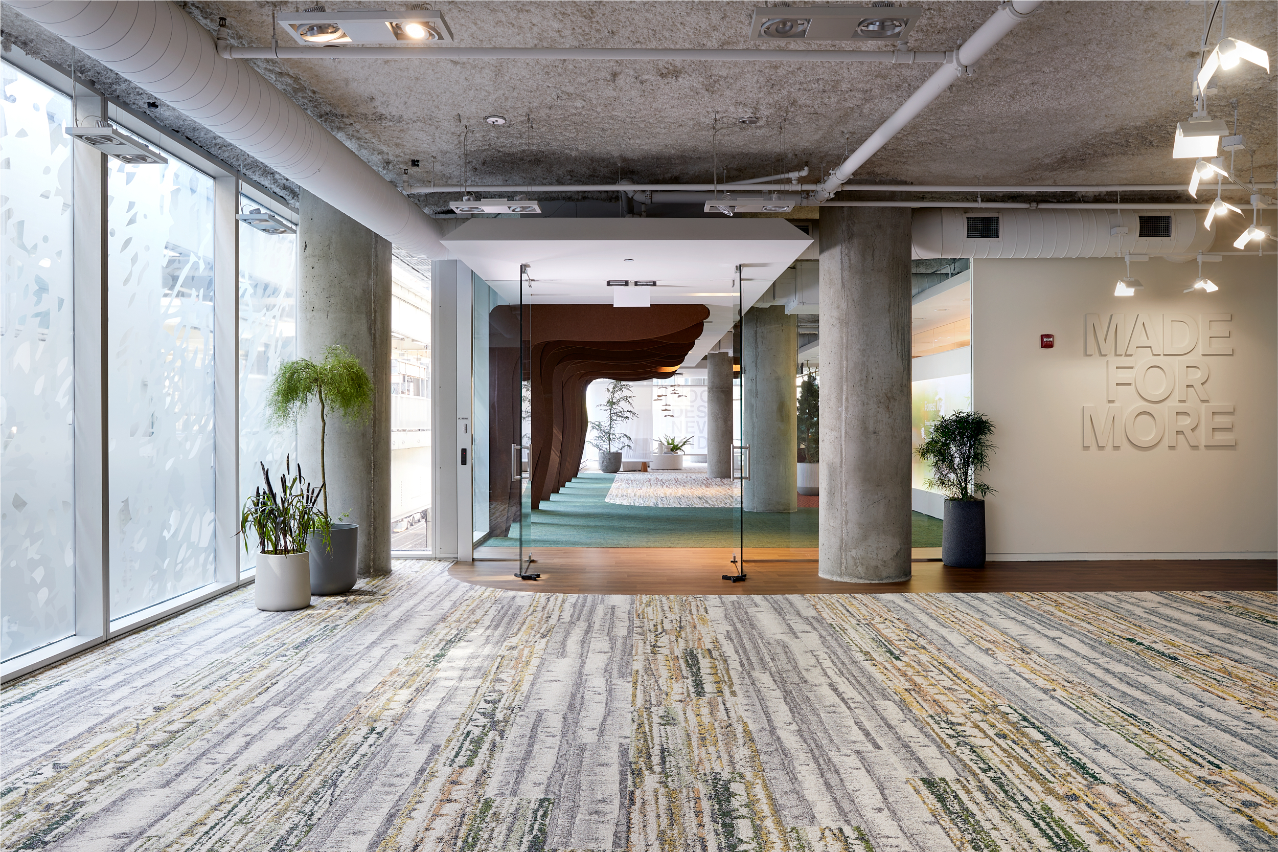 Interface Shifting Seasons, Quiet Grove and Spruce it Up plank carpet tiles with nora by Interface noravant timber rubber flooring in corporate showroom entryway