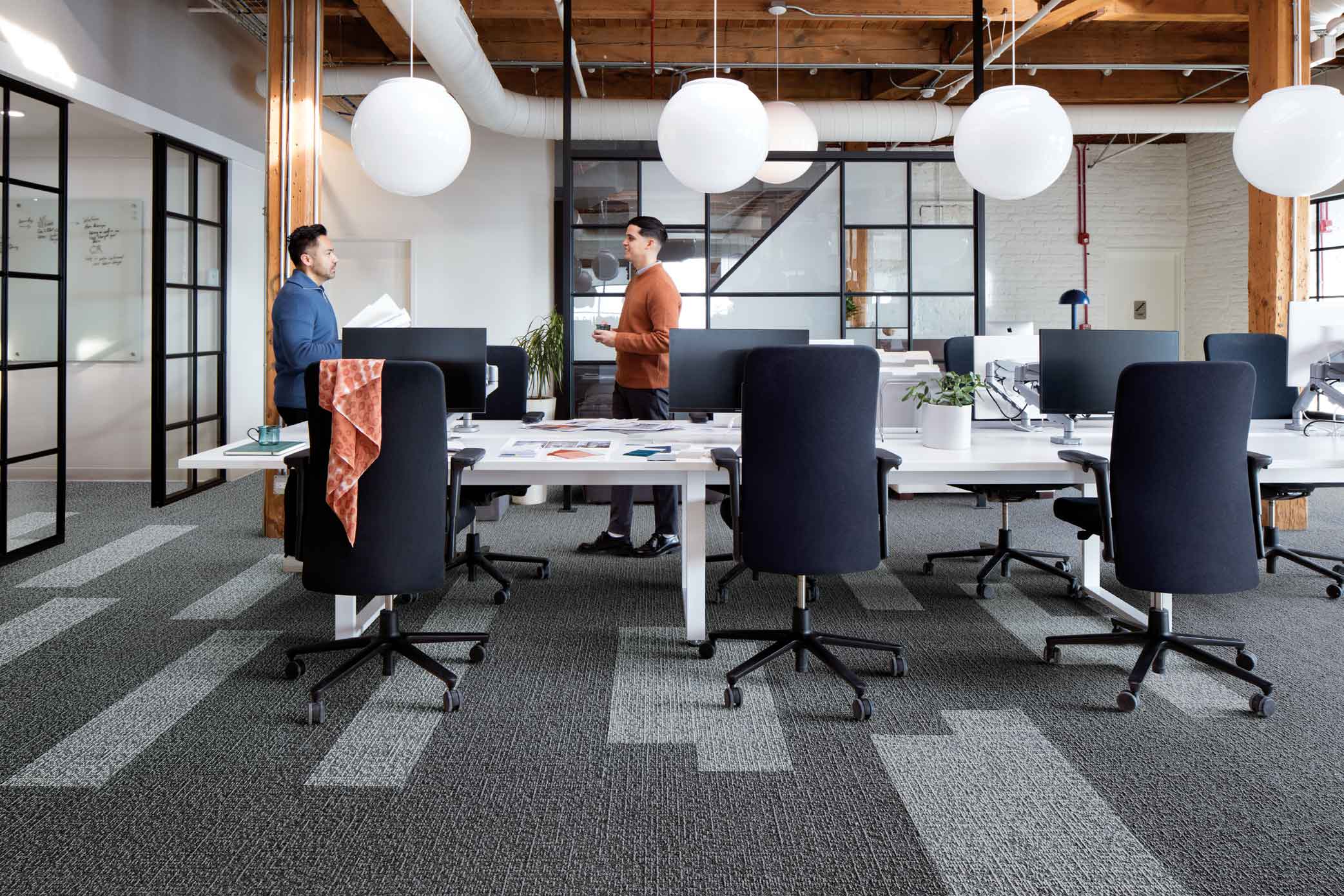 Interface Sashiko Stitch plank carpet tile in meeting room with two men talking