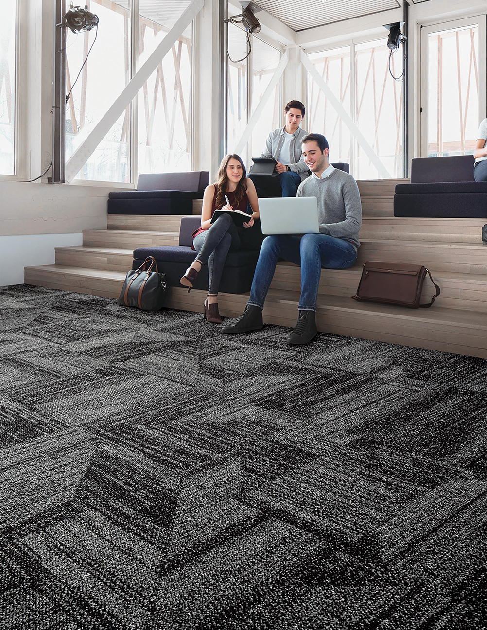 Interface Open Air 403 carpet tile with group working on built in wood stairs