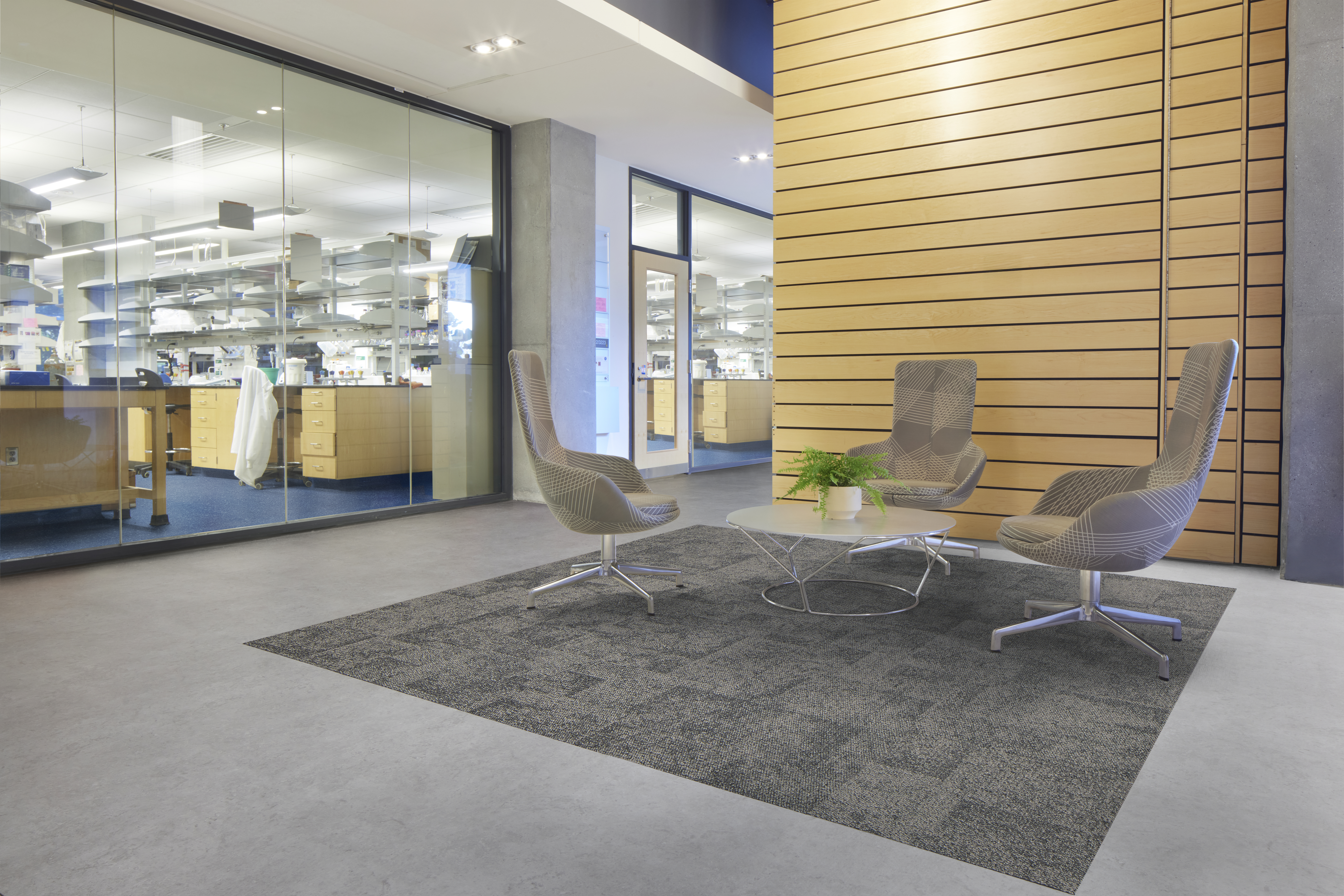 Interface carpet tile and LVT in lobby area with norament grano rubber flooring in laboratory