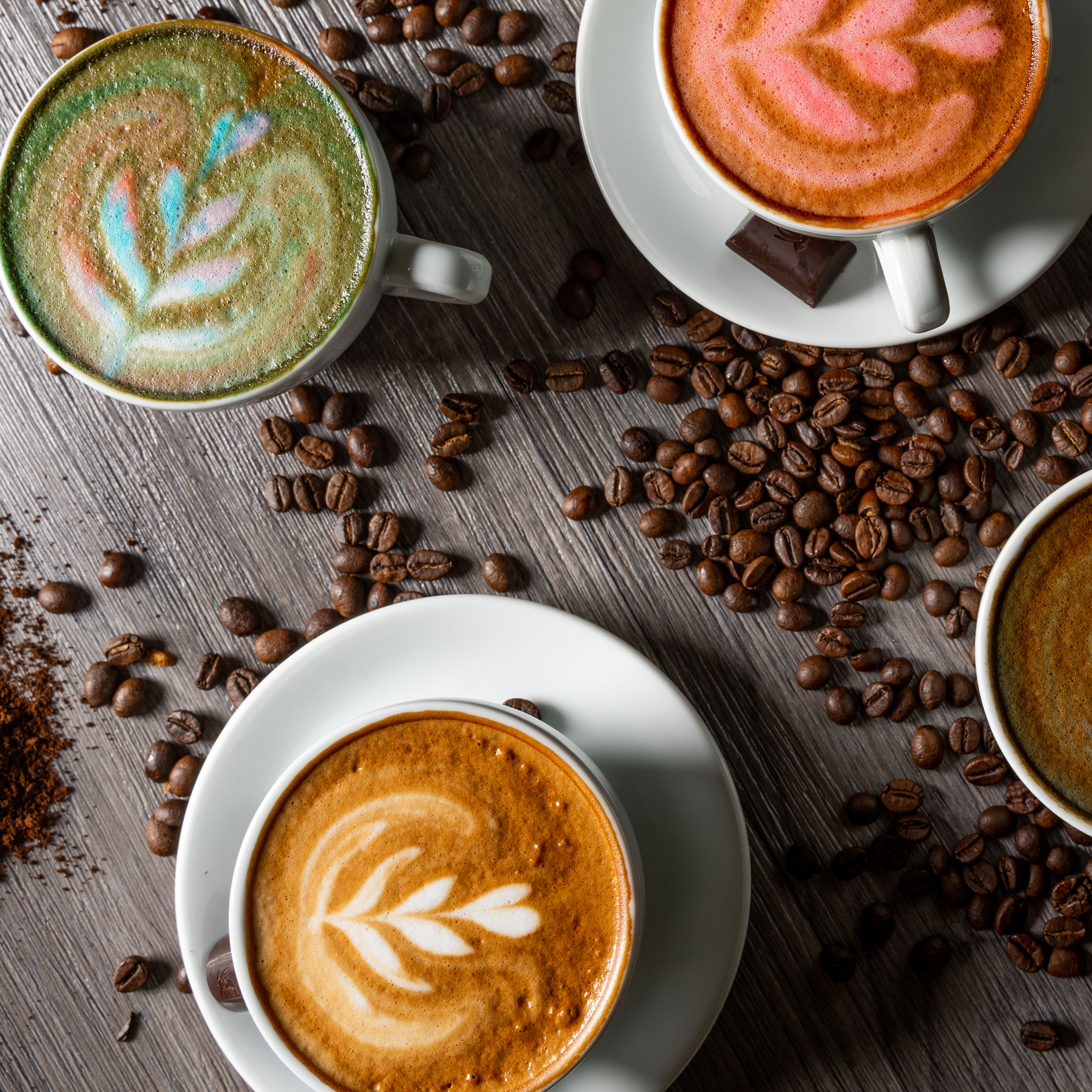 Cups of coffee on table with beans